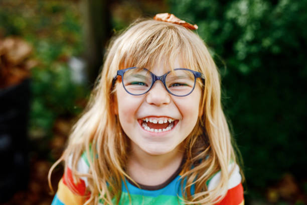 Laughing girl with glasses and blonde hair